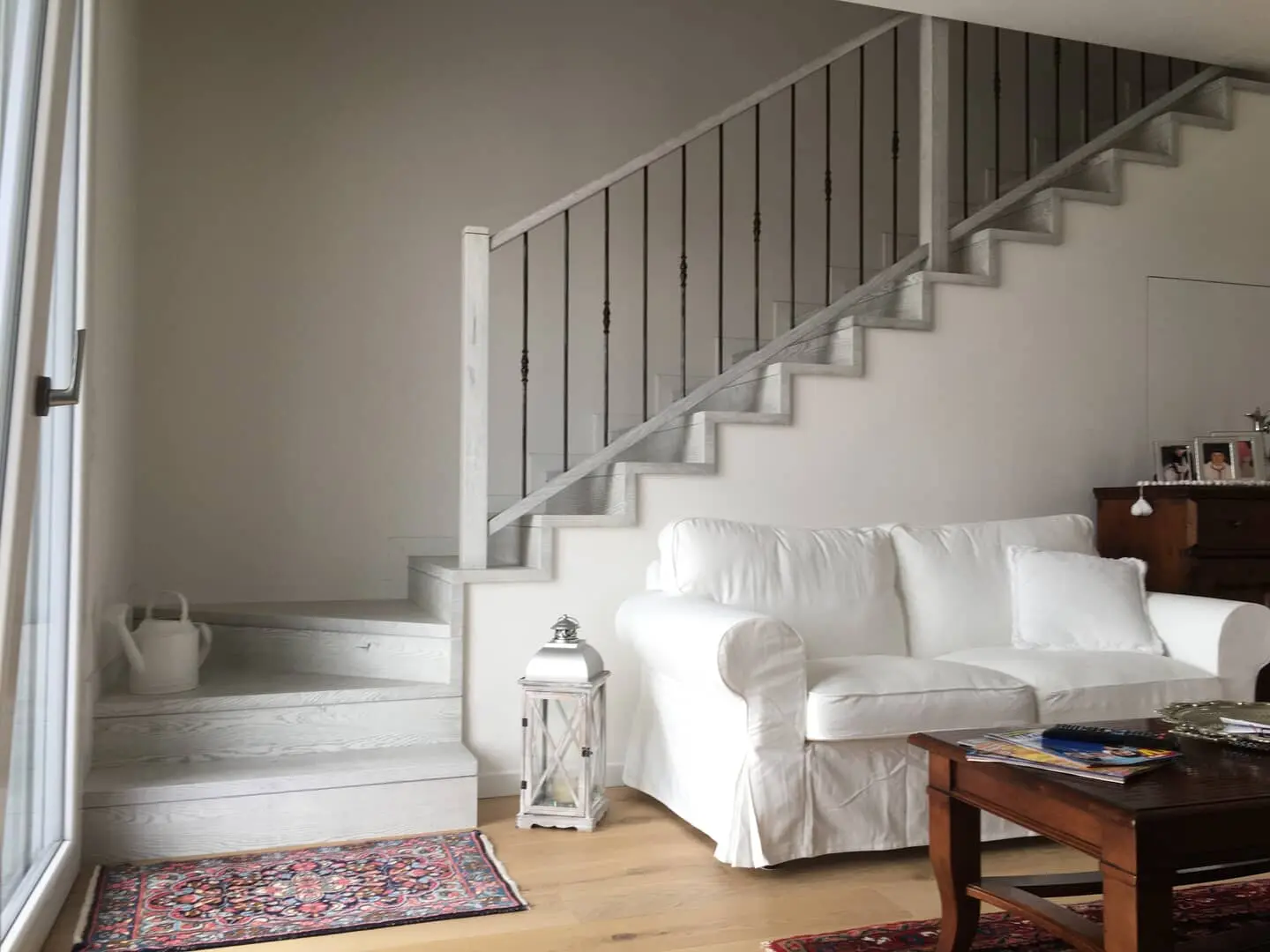 Salotto con scala di design in legno.
